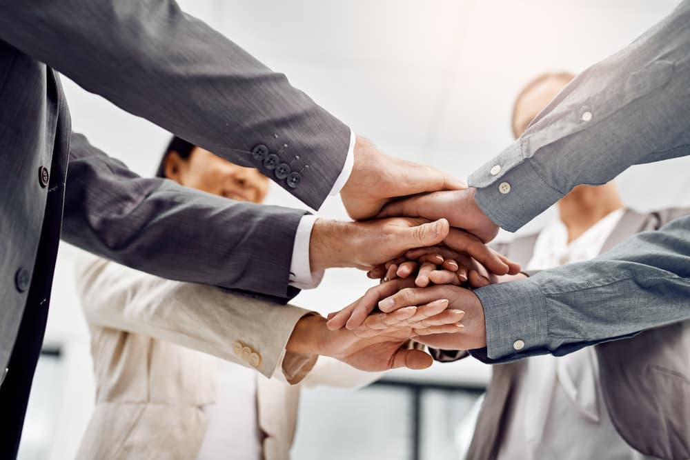 Hands, stack and group of business people in office for team building, motivation and solidarity.