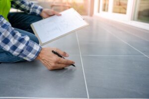 Engineer is inspecting construction check tiled floor.