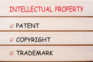 Patent, copyright and trademark written on wood wall decor.