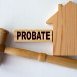 PROBATE - word on a wooden block on the background of a house and a referee's gavel