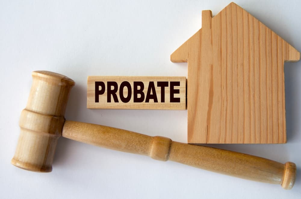 PROBATE - word on a wooden block on the background of a house and a referee's gavel