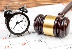 A clock on calendar with judge's gavel