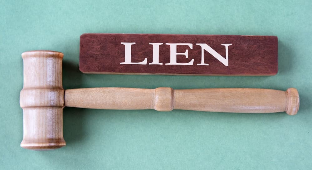 LIEN - word on brown block with judge's gavel.